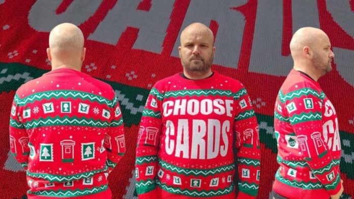 Matt Simpson, owner of The Letter Arty, modelling the Choose Cards Christmas jumper