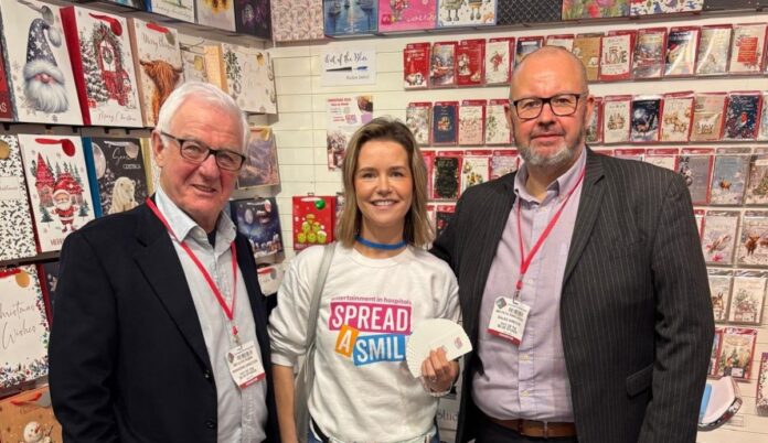 Photo from Naomi (1) Spread a Smile visit manager Amy Berry with Out of the Blue Studios MD Clive Rubin (left) and sales director & co-owner Pete Rawlingson